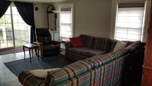 Living room with windows facing the backyard